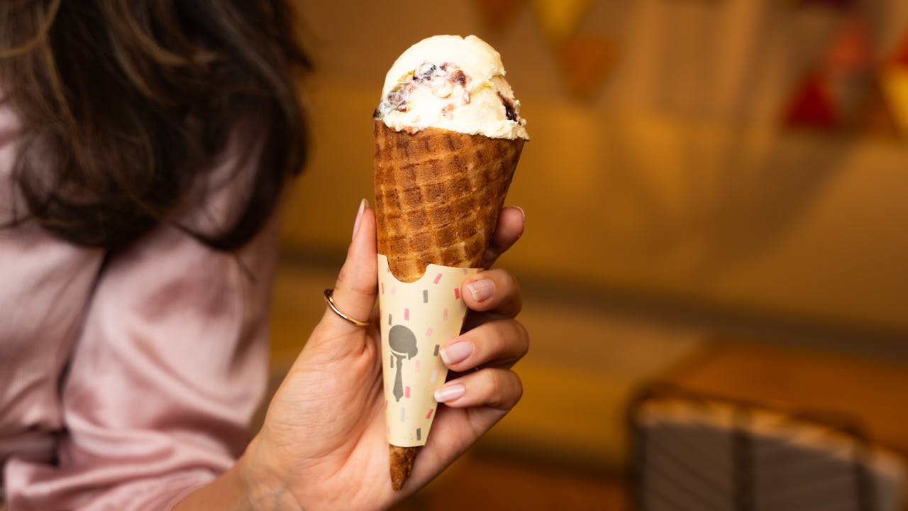 Creamy Ice Cream in Crispy Waffle Cone with Chocolate Drizzle